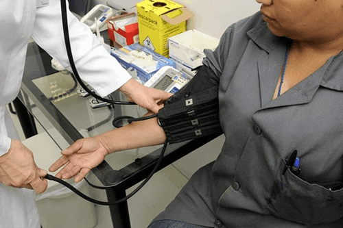 A woman receiving a blood test from a doctor.