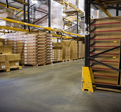 Boxes stacked high in a warehouse.