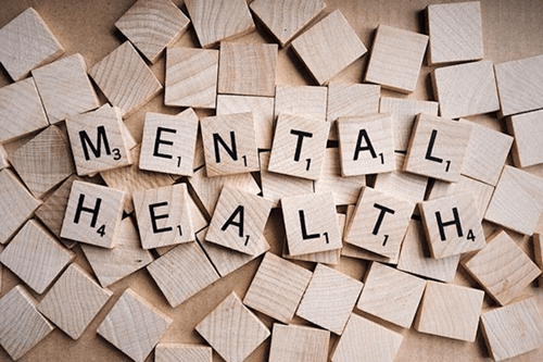 Mental health spelt out on wooden blocks.