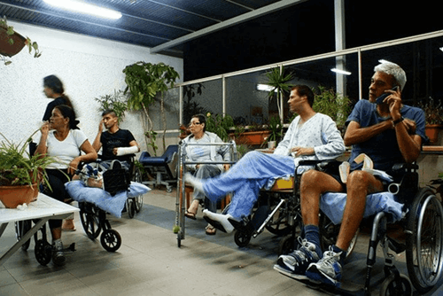 People sitting on wheelchairs.