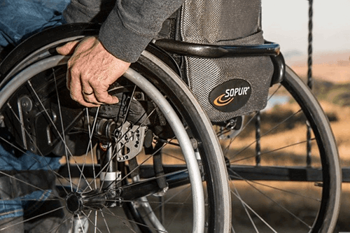 A person facing disability discrimination because of their wheelchair.