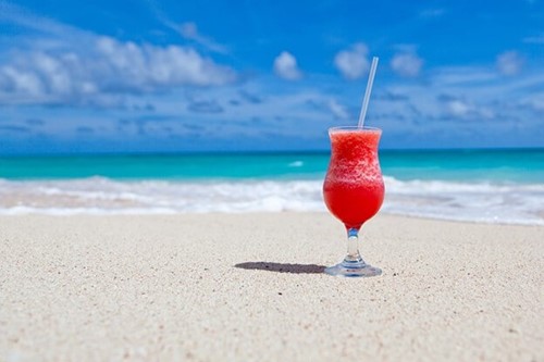 An ice cold drink on a sandy beach