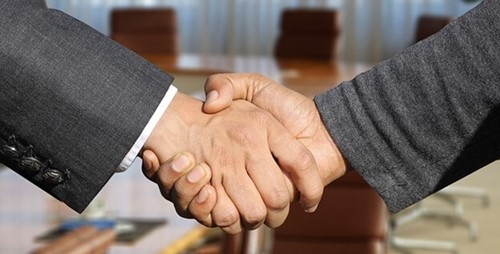 two people shaking hands after a deal
