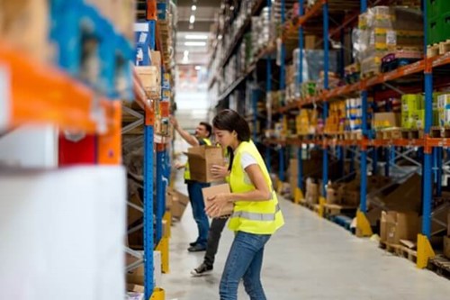 two warehouse workers stacking shelves